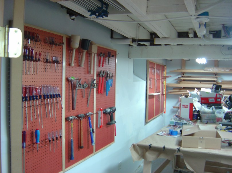 Filling up the pegboards with copper painted hardware