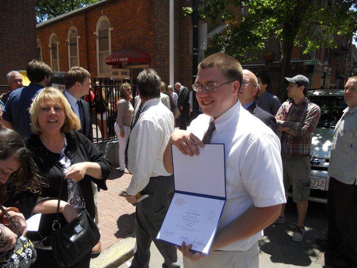 John O'Rourke proudly showing off his diploma