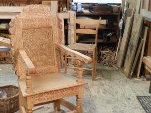 Beautiful carved chair. In the background a chair built to the specs from 'Make A Chair From A Tree : An Introduction To Working Green Wood' which was the inspiration for Peter's 'Make a joint stool from a tree' book. 
