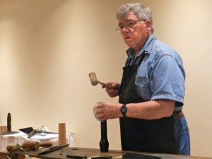 Bill McMillen demonstrating how to tinsmith as he makes a cup