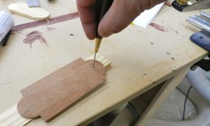 Drill mounting holes with a brad awl