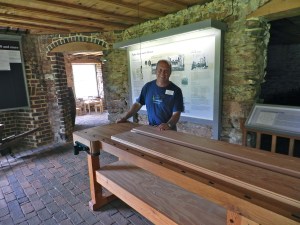 Senior Restoration Craftsman David Clauss with the long joiner's bench he build