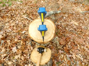 Splitting the oak log with metal wedges and a heavy leather faced mallet