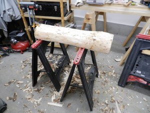 Removing the bark from the half log