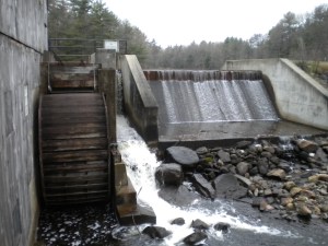 The mill is powered by a large water wheel which is fed by an adjacent pond.