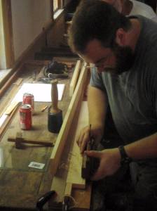 Demonstrating the use of a molding plane on a sticking board. (Photo by Carol Coutinho)
