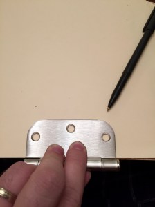 Use one of the hinges as a template. 