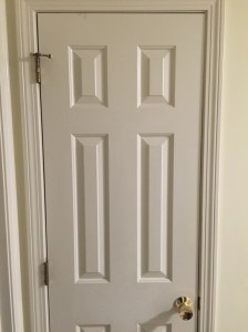 BEFORE: Existing door with brass hardware sagging