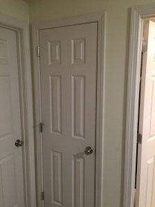 AFTER: Properly adjusted door with new Schlage 'Georgian' style knobs. The knobs and hinges are finished in brushed nickel. 