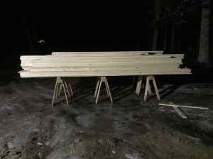 A LOT of shiplap siding on horses. 10-12" wide 16' long pieces