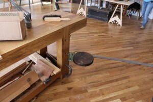 Nice swing out adjustable seat attached to the workbench leg 