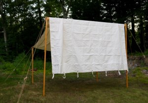 Raise the center beam, secure the support ropes and set the exterior posts and ropes. 