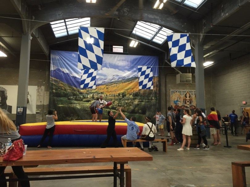 Folks jousting American Gladiator style in full on lederhosen.