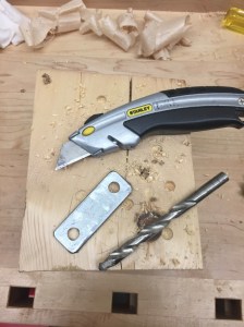 Use a utility knife to clean up the cork around the edges of the plate and the 3/8' drill bit to clean up and cork in the holes