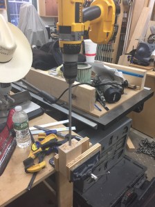 Use a long electrician's style 3/8" drill bit to finish the centered hole. 